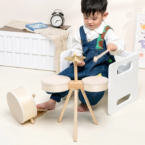Minimalist wooden drum set for kids featuring a bass drum with pedal and tripod stands