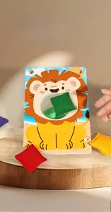 Detail view of lion-themed wooden toss board with colorful sandbags for kids game