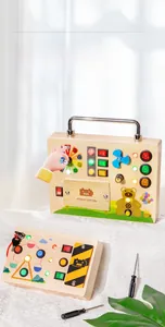 Close-up of wooden Montessori busy board with colorful LED lights, switches and a fan