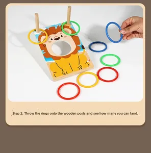 Hand throwing colorful rings onto a wooden lion base toy for toddler skill training