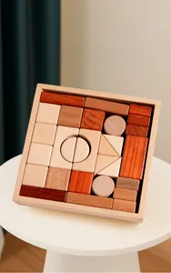 Detail of assorted solid wood geometric building blocks in a natural wooden storage tray