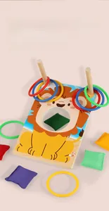 Detail of wooden cartoon lion board with colorful plastic rings and soft bean bags