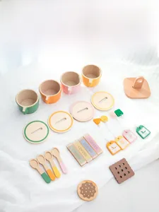 Detail of wooden tea play set including colorful cups, spoons, and toy tea bags