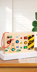 Detailed view of wooden busy board toy with colorful LED switches and toggle buttons