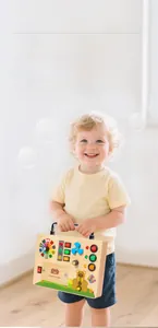 Detail of wooden sensory busy board with colorful LED switches and spinning fan for toddlers