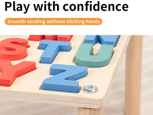 Detail of large colorful wooden alphabet blocks on smooth sanding activity table