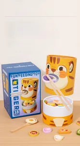 Detail view of tiger feeding toy set with wooden spoons, chopsticks and colorful play food