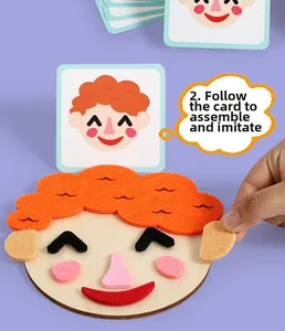 Macro view of child assembling DIY felt face puzzle using guided cartoon expression cards