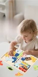 Close-up of thick wooden puzzle pieces showing dinosaur and ocean animal themes for kids