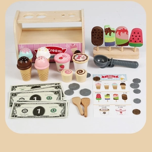 Close-up of wooden ice cream play set with cones, colorful popsicles and play money