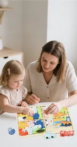 Close-up of mother and child playing with animal and vehicle wooden puzzle set