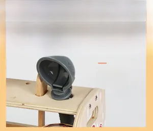 Close-up of storage holes on wooden ice cream toy stand for spoon accessories