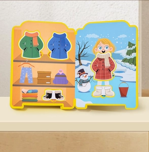 Detail view of children's EVA dressing book with wardrobe stickers and winter snow scene