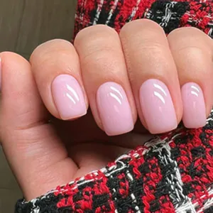 Detail of medium square press-on nails in glossy soft pink with jelly-like finish