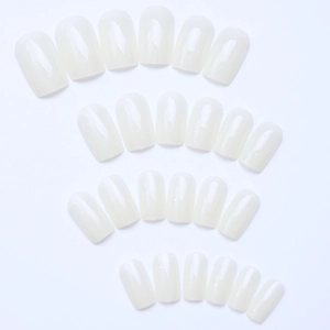 Detailed view of glossy cream white medium square artificial nail tips set on white background