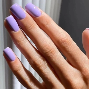 Detailed view of long square lilac press-on nails with a glossy solid color finish