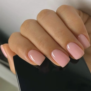 Detail of nude pink square press-on nails with a high-gloss jelly texture finish