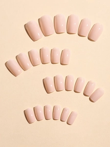 Glossy square nude false nails set arranged in multiple sizes on neutral background