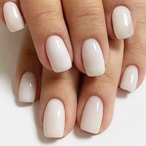 Macro detail of glossy ivory white medium square press-on nails with high-shine finish