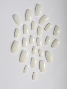 Detail view of square ivory white press-on nail set in various sizes for women