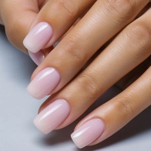 Close-up of elegant translucent jelly pink medium square press-on nails with glossy finish