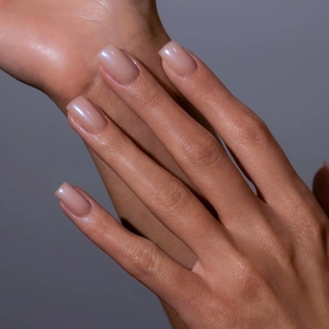 Macro view of medium square press-on nails in iridescent pearlescent nude pink color