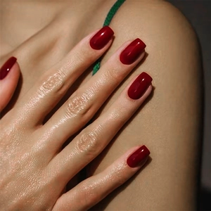 Macro detail of glossy dark red solid color square-shaped press-on nails for women