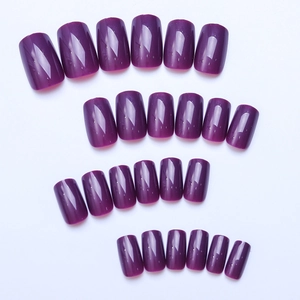 Macro view of 24 dark purple square-oval press-on nails with high-gloss finish on white background