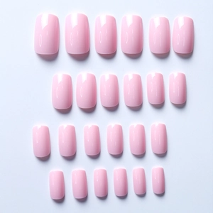 Flat lay showing 24 pieces of glossy soft pink square-round press-on nail set on white