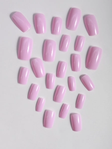 Detail of glossy pink press-on nails in various sizes for a perfect minimalist manicure