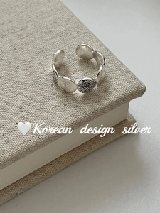 Detail of S925 sterling silver ring with textured oval plates and adjustable band
