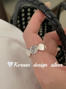 Detail of S925 sterling silver ring with textured oval plate and sleek retro design