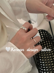 S925 sterling silver ring set with textured oval finish and minimalist band on hand