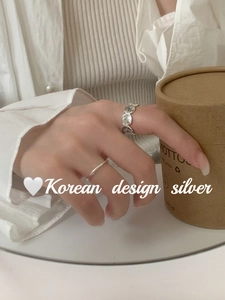 Detail view of two S925 silver rings with vintage textures and minimalist smooth band