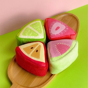 Detailed view of plush fruit coin purses in strawberry, lime, apple, and watermelon shapes