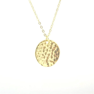 Detail view of the hammered golden disc pendant on a fine S925 sterling silver chain