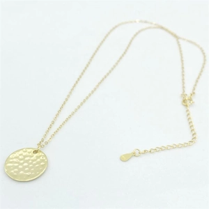 Detail of gold S925 sterling silver hammered texture round pendant with lobster clasp