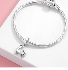Macro view of S925 silver charm bracelet featuring a blue enamel scooter pendant