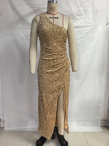 Detail of champagne gold sequined one-shoulder dress with side ruching and a high slit