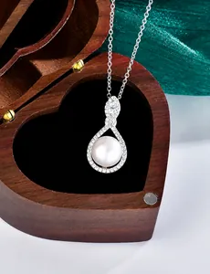 Detailed macro view of S925 silver moissanite pendant with white pearl in a jewelry box