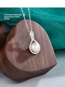 Detail view of S925 silver necklace with teardrop pendant and large lustrous pearl