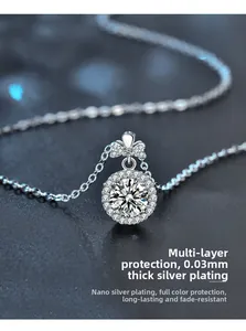 Macro view of S925 silver necklace with moissanite perfume bottle pendant and bow detail