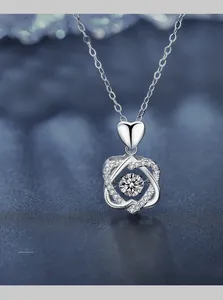 Macro shot of 925 sterling silver heart necklace with 3EX cut dancing moissanite stone