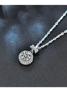 Macro shot of S925 silver sunflower pendant necklace with moissanite and bow detail