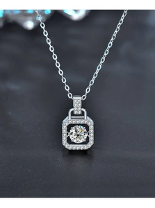 Close-up of dancing moissanite square pendant necklace with brilliant cut stone