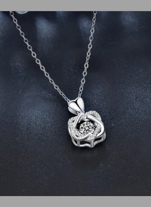 Macro shot of S925 silver heart petal necklace with a moissanite center stone sparkle