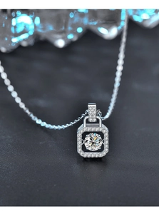 Macro shot of S925 sterling silver square pendant with a dancing moissanite center stone