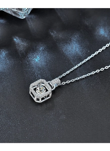 Macro shot of S925 silver moissanite dancing heart pendant on deep blue texture