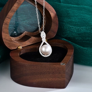 Elegant S925 sterling silver necklace with a round pearl pendant in a heart-shaped wooden box