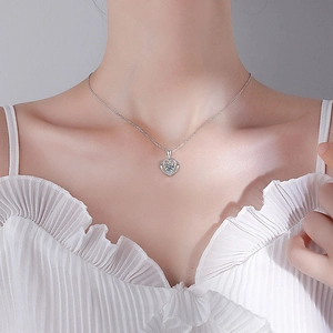 Moissanite heart pendant necklace in S925 sterling silver worn by a female model